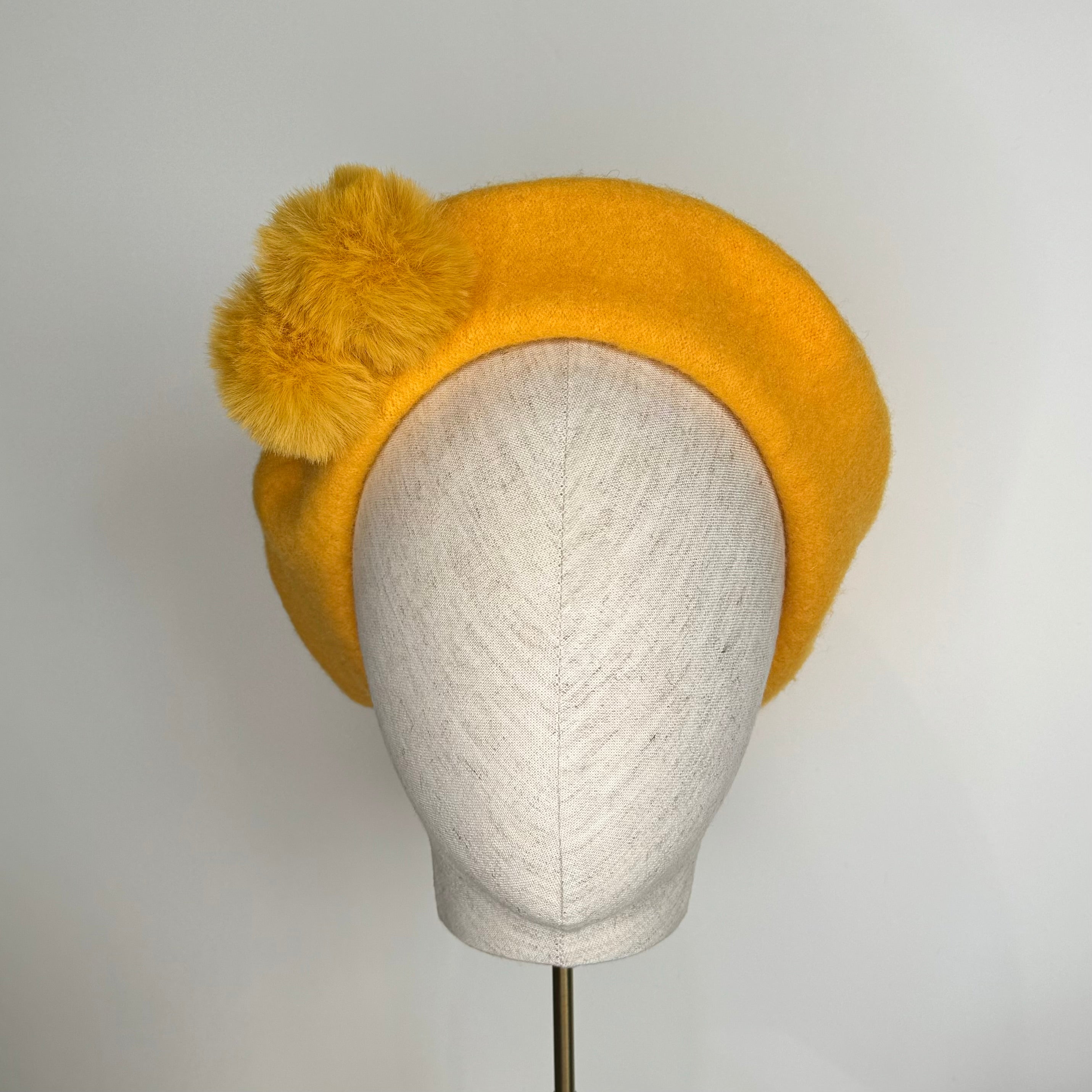 Yellow beret with Pom poms